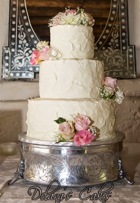 If you have already selected a wedding cake designer, they will advise you on what frosting would be best based on the types they work with, their design style, and your wedding aesthetic. Delana's Cakes: Textured icing Wedding Cake