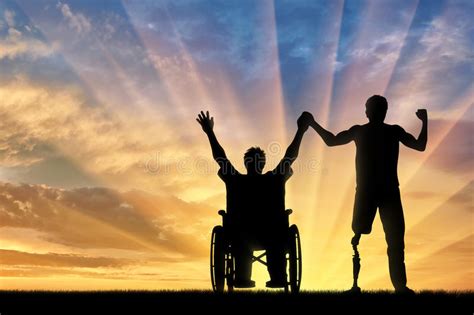 Disabled With Prosthesis And In Wheelchair Holding Hands Sunset Stock