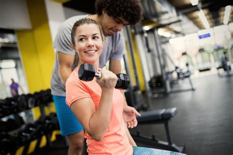 Beautiful Woman Doing Exercises In Gym With Personal Trainer Stock Image Image Of Female