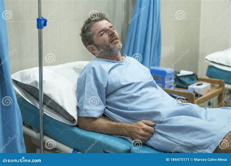 Injured Man Lying In Bed Hospital Room Resting From Pain Looking In Bad