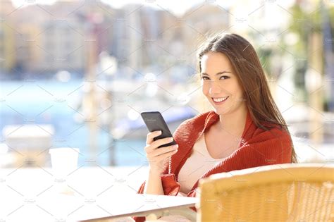 Woman holding a phone in a coffee sh | High-Quality Technology Stock ...