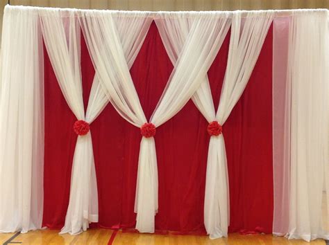 Red And White Drapes With Flowers On Them Are Set Up For A Wedding Ceremony