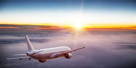 Commercial Airplane Jetliner Flying Above Dramatic Clouds Stock Image