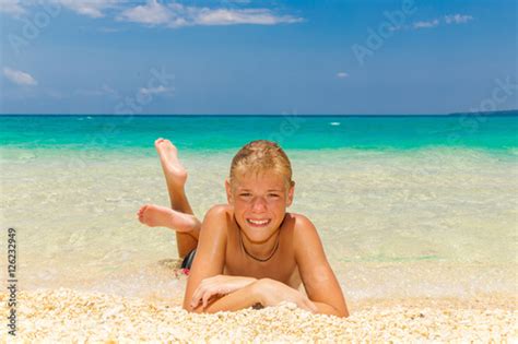 Happy Teen Boy Relaxing On The Beach Tropical Sea In The Backgr Buy This Stock Photo And