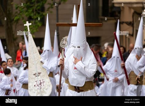 People Dressed In Religious White Hoods Of Penance During The Easter