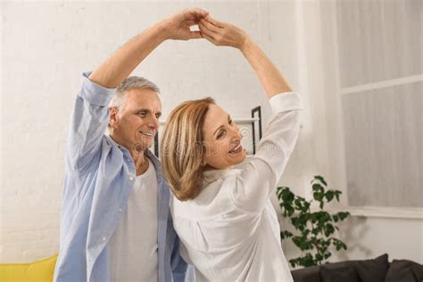 Happy Senior Couple Dancing In Living Room Stock Photo Image Of