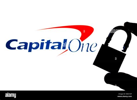 Capital One Bank Logo On The Background Screen And A Silhouette Of The