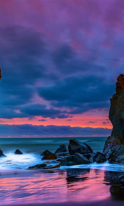 Rocks Stones On Ocean Waves Beach Sand Reflection Under Light Purple