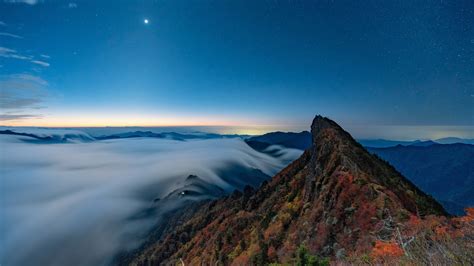 1920x1080 Fog Covering Horizon Mountains Under Blue Sky 1080p Laptop