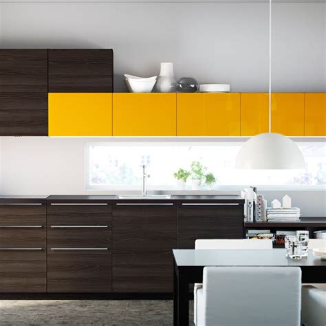 Contemporary kitchens that feel more like living areas than cooking spaces are a welcoming decorating trend. A dark, modern kitchen style can be dressed up with bright yellow. | Ikea kitchen cabinets, Ikea ...