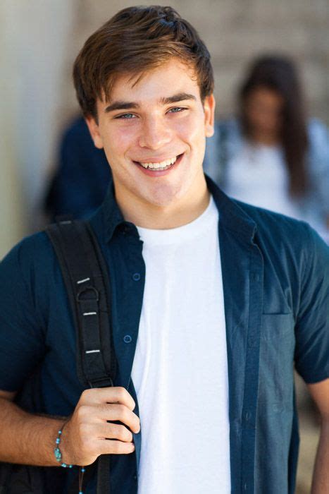 A School Portrait Of Happy Male High School Student Smiling In A School