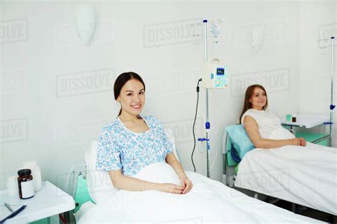 Happy Young Woman Lying In Bed In Hospital Stock Photo Dissolve