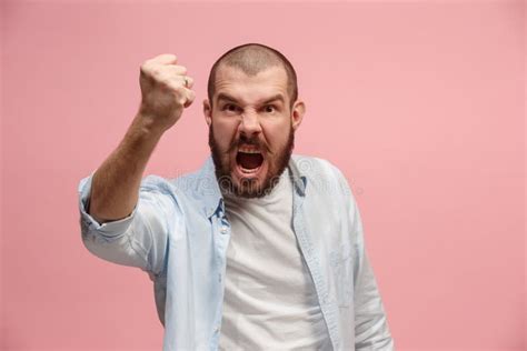 The Young Emotional Angry Man Screaming On Pink Studio Background Stock