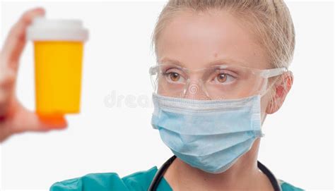 Female Doctor Nurse Holding A Bottle Of Pills On White Background
