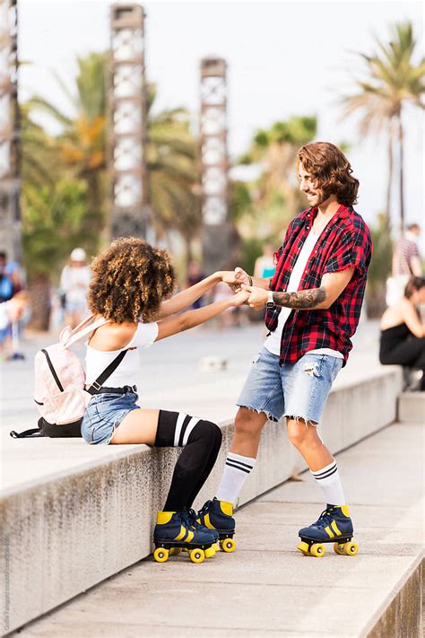 Couple On Roller Skates On Street By Stocksy Contributor Guille