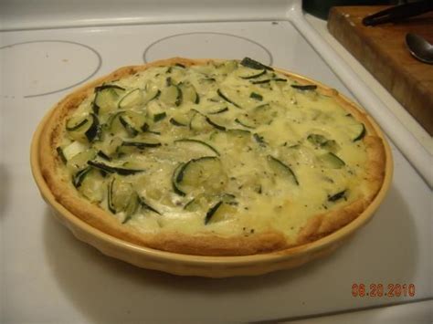 A Baked Dish With Zucchini And Cheese In A Pan On Top Of The Stove