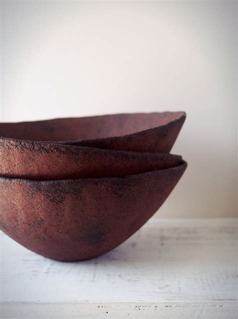 Three Brown Bowls Sitting On Top Of A White Table
