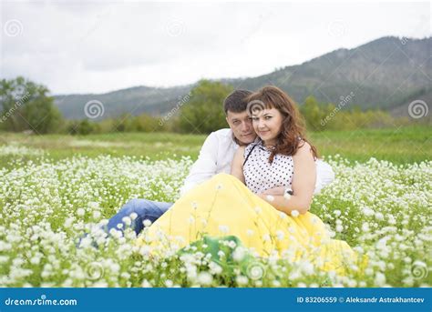 Lovers Meet Men And Women On A Beautiful Flower Field Stock Image