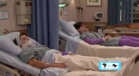 Two People Laying On Beds In A Hospital