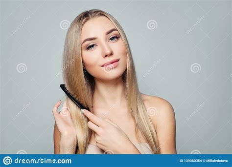 Beautiful Blonde Woman With Long Healthy Straight Hair Combing Hair Haircare Concept Stock