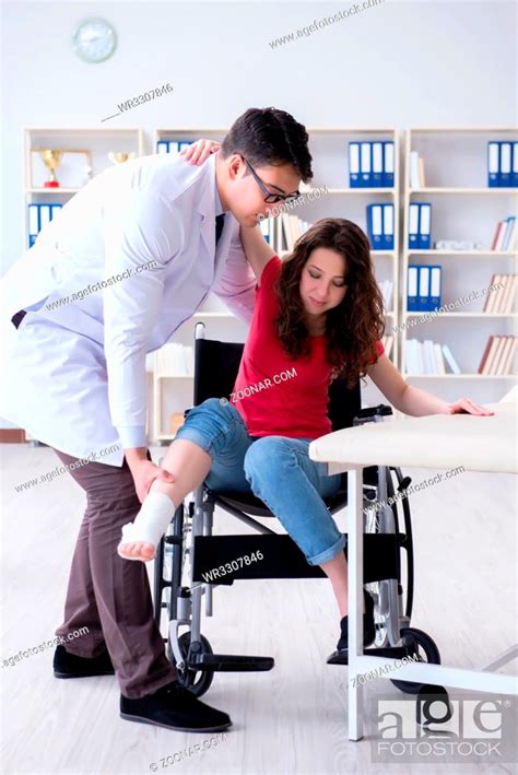 Doctor And Patient During Check Up For Injury In Hospital Stock Photo