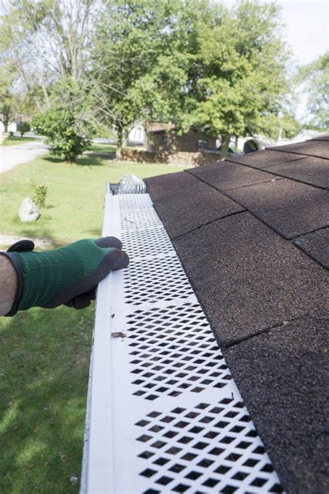 Many styles are designed to slide underneath the last layer of roof shingles. How to Install Gutter Guards | Hunker