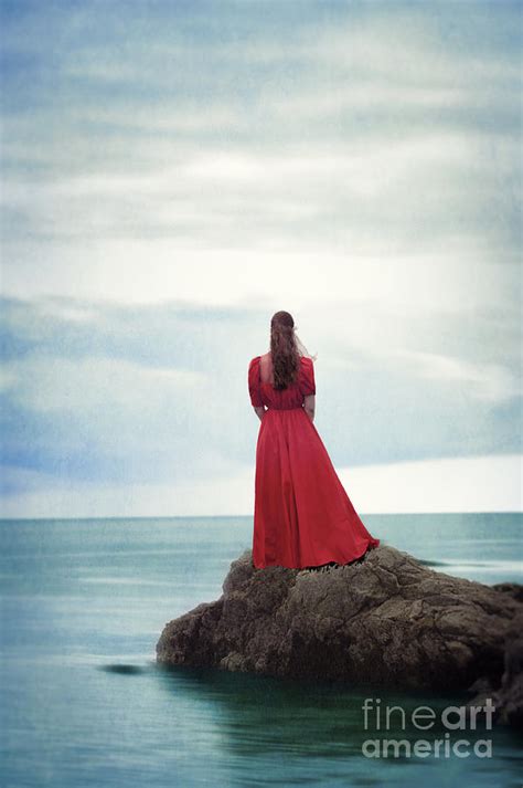 Woman Standing On A Rock In The Ocean Looking Out To Sea Photograph By