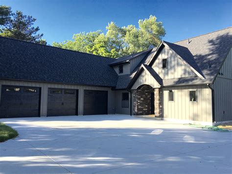 They fall into two main categories depending on. Dark grey vertical steel siding with black garage doors ...