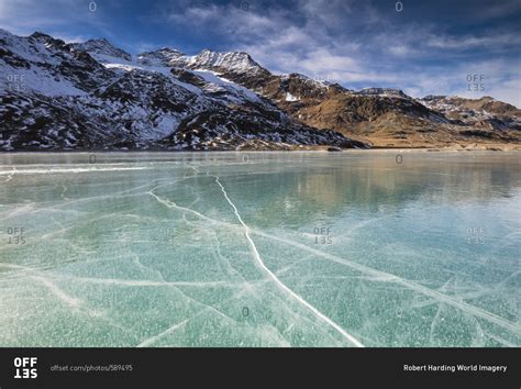 The Snowy Peaks Frame The Frozen Turquoise Water Of White Lake Lago