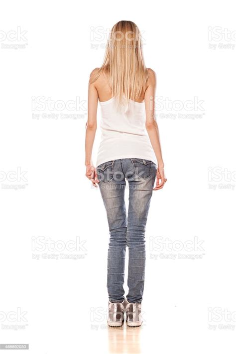 Rear View Of Skinny Blonde Girl Standing On White Background Stock