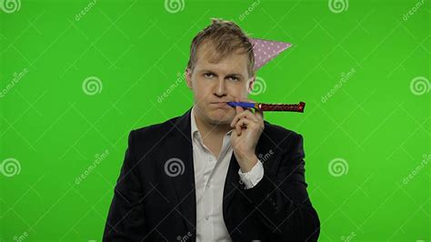 Drunk Disheveled Young Businessman In Festive Cap Blowing A Whistle Hangover Stock Image