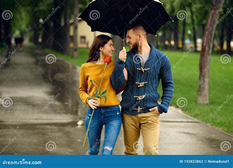 Romantic Couple With Umbrella Walking In Park Stock Photo Image Of