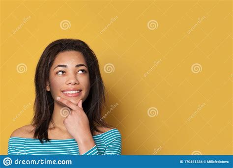 Indoor Portrait Of Beautiful Young Brunette Woman Smiling And Looking