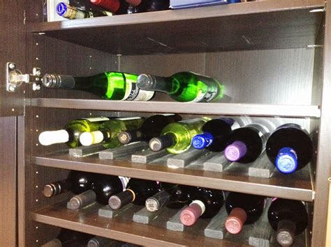 Then, peel the gray felt off the edges of the kallax insert for bottles and assemble the pieces of the wine insert. Besta Wine Rack and Liquor Cabinet - IKEA Hackers