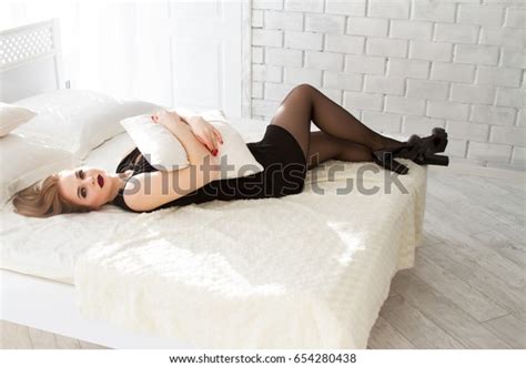 Girl Black Dress Lying On Bed Shutterstock