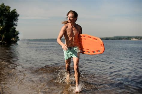 Premium Photo Strong Sexy Beach Lifeguard Running Along The River