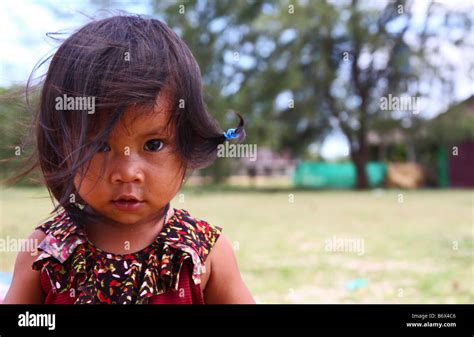 Close Up Portraits Of Very Young And Cute Cambodian Girl Looking At The