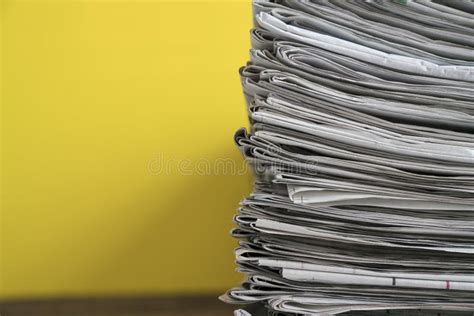 Newspapers Folded And Stacked Background On The Table Stock Photo