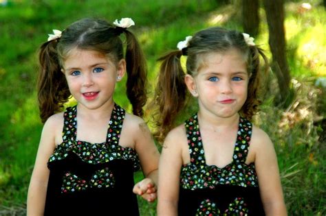 Two Sisters Twins With The Same Hairstyles In Identical Dresses Free Image Download