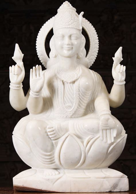 White Marble Seated Lakshmi Holding 2 Lotus Flowers In Varada And Abhaya