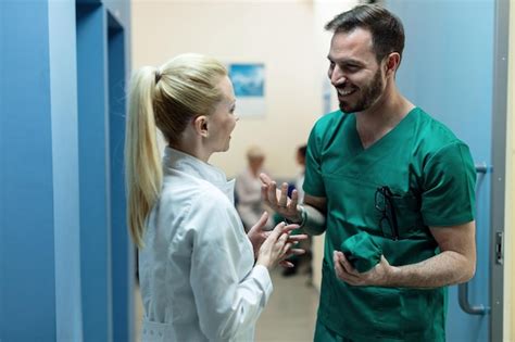 Premium Photo Happy Surgeon Talking To Female Doctor While Standing
