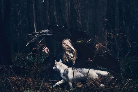 Haunting Fantasy Of A Woman Running With Wolves In A Forest