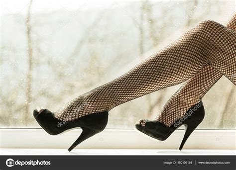 Sexy pernas femininas em meias meia calça preta no peitoril da janela fotos imagens de