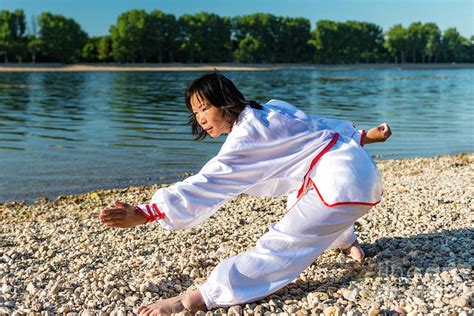 Women Practicing Tai Chi By Lake Photograph By Microgen Imagesscience