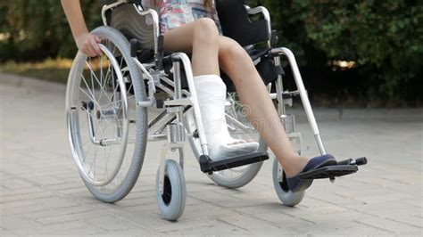 A Girl With A Broken Leg In A Wheelchair Stock Video Video Of