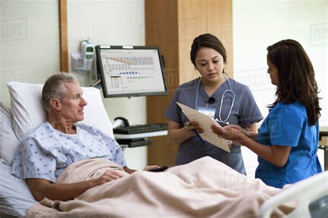 Nurses And Patient Talking In Hospital Room Stock Photo Dissolve