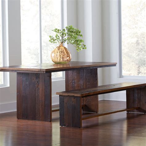 The table top is made from reclaimed elm doors in a natural finish and has a metal gallery reminiscent of antiques from past. Reclaimed Elm Dining Table | VivaTerra