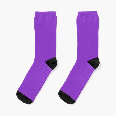 Two Pairs Of Purple Socks Sitting Next To Each Other