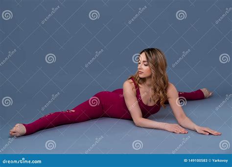 Fit Sporty Girl Is Stretching Young Beautiful Gymnast Woman In A Jumpsuit Doing Cross Split