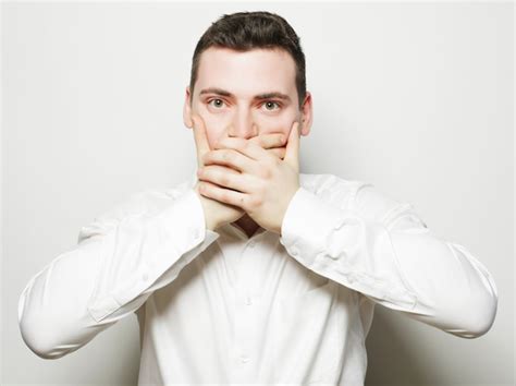 Premium Photo Shocked Young Man Covering Mouth With Hands